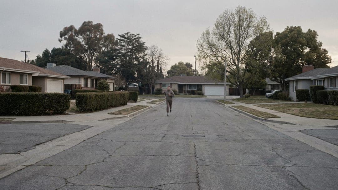 A runner setting out on a suburban street