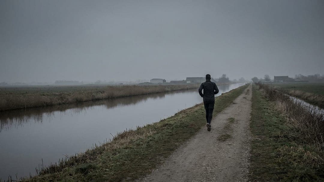 A runner checking a watch mid-stride